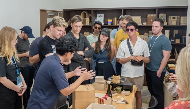 Builders gathered around a craft workshop demonstration